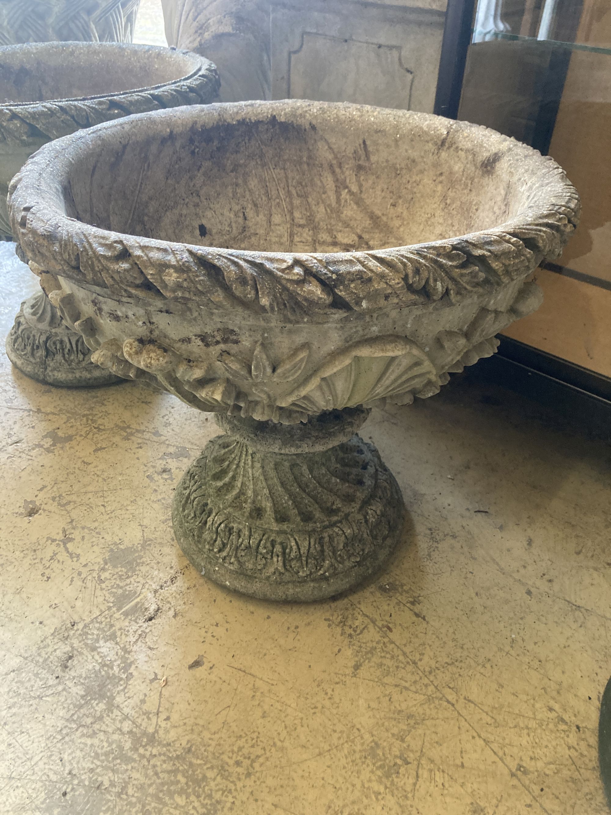 A pair of reconstituted garden stone planters, 54cm diameter, height 51cm